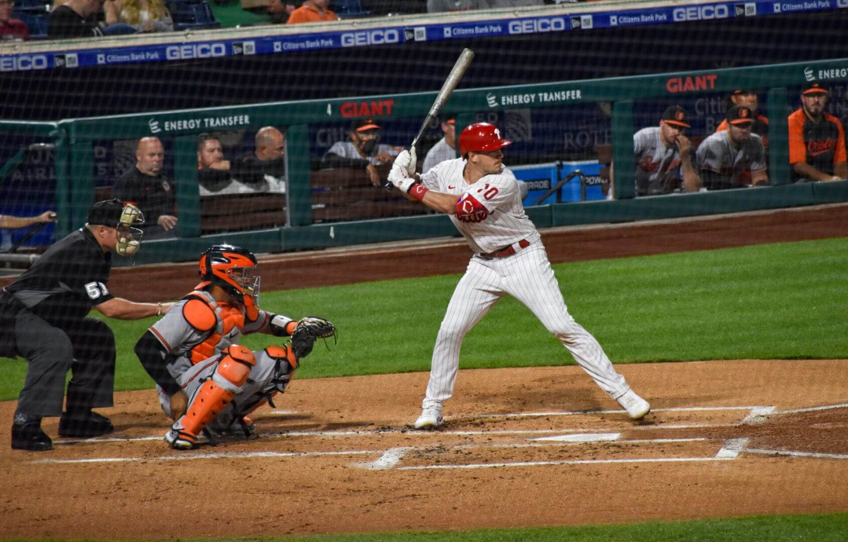 Baseball batter poised to swing, catcher crouched