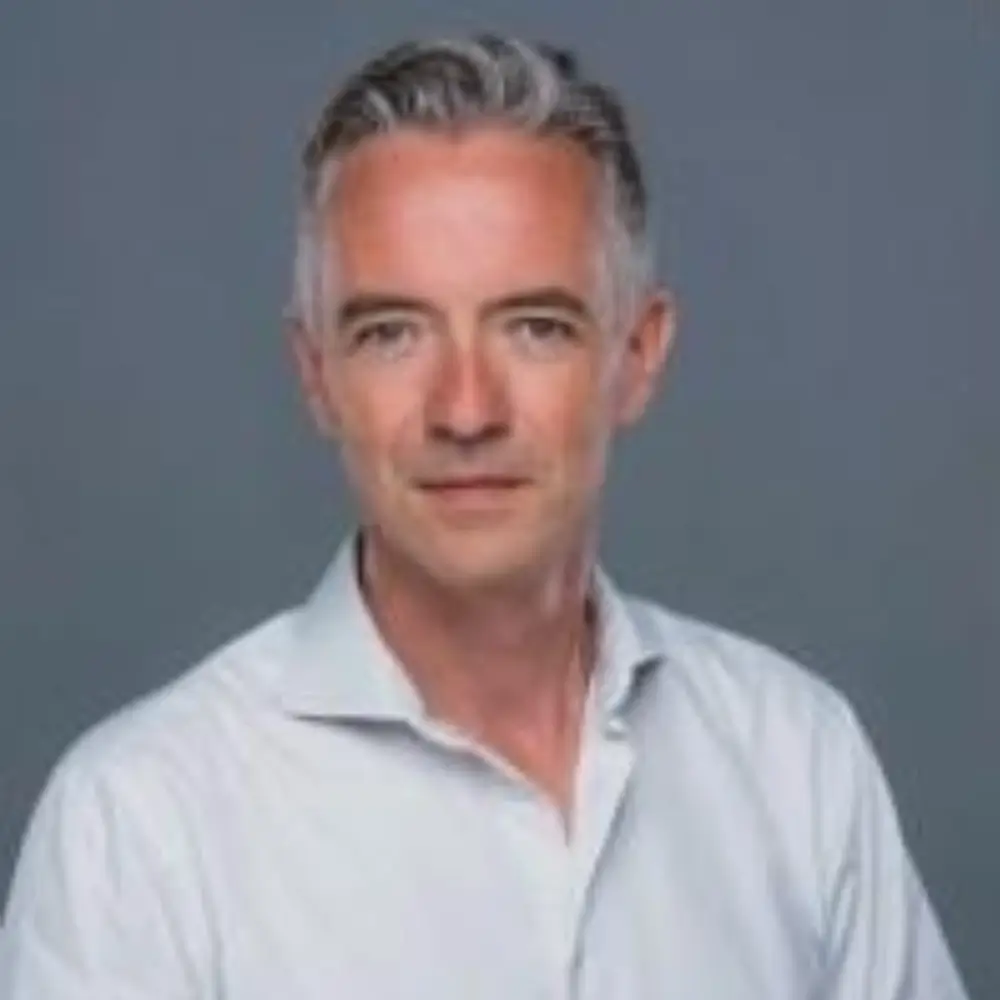 Confident grey-haired man in white shirt