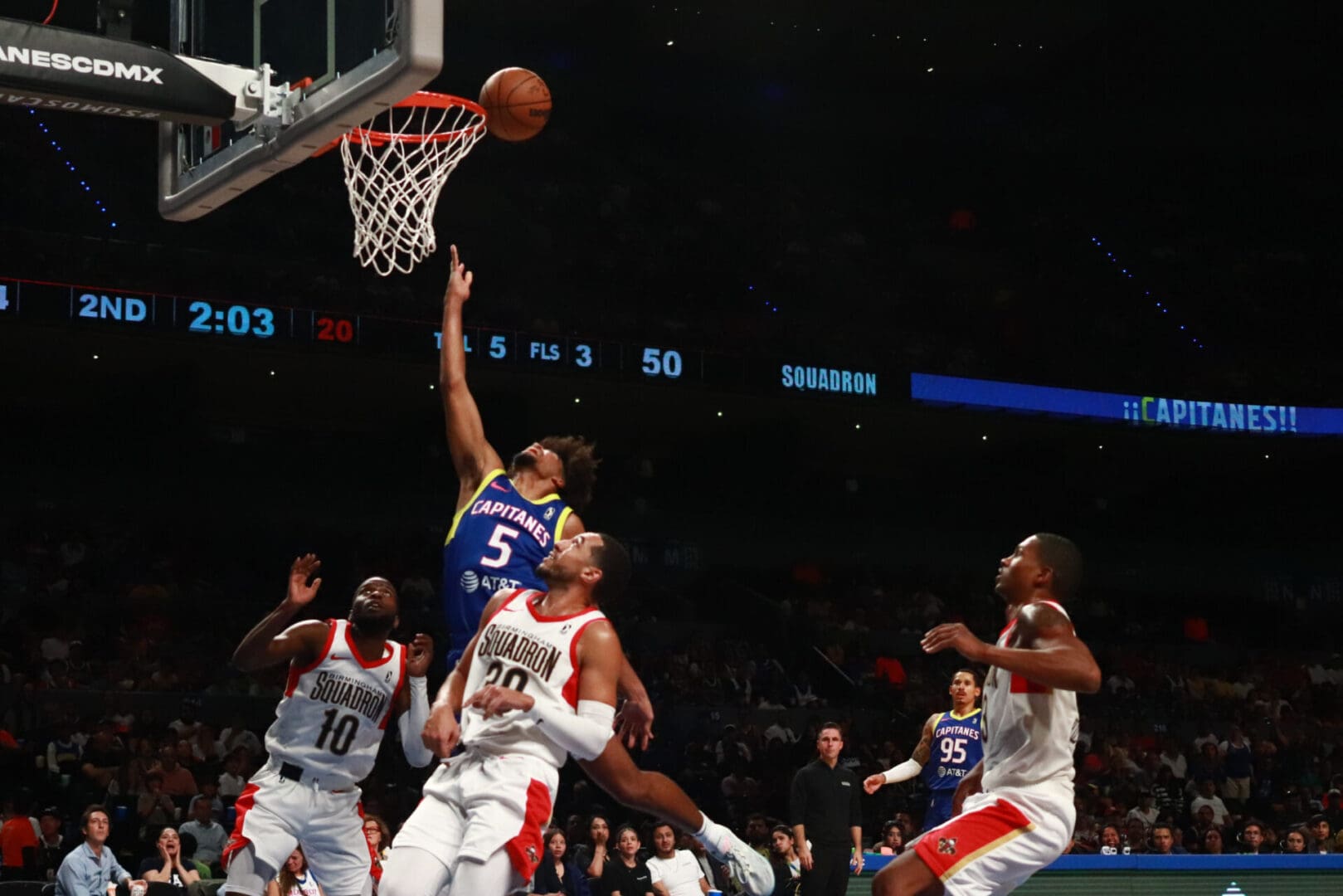Player in purple attempting layup amid defenders