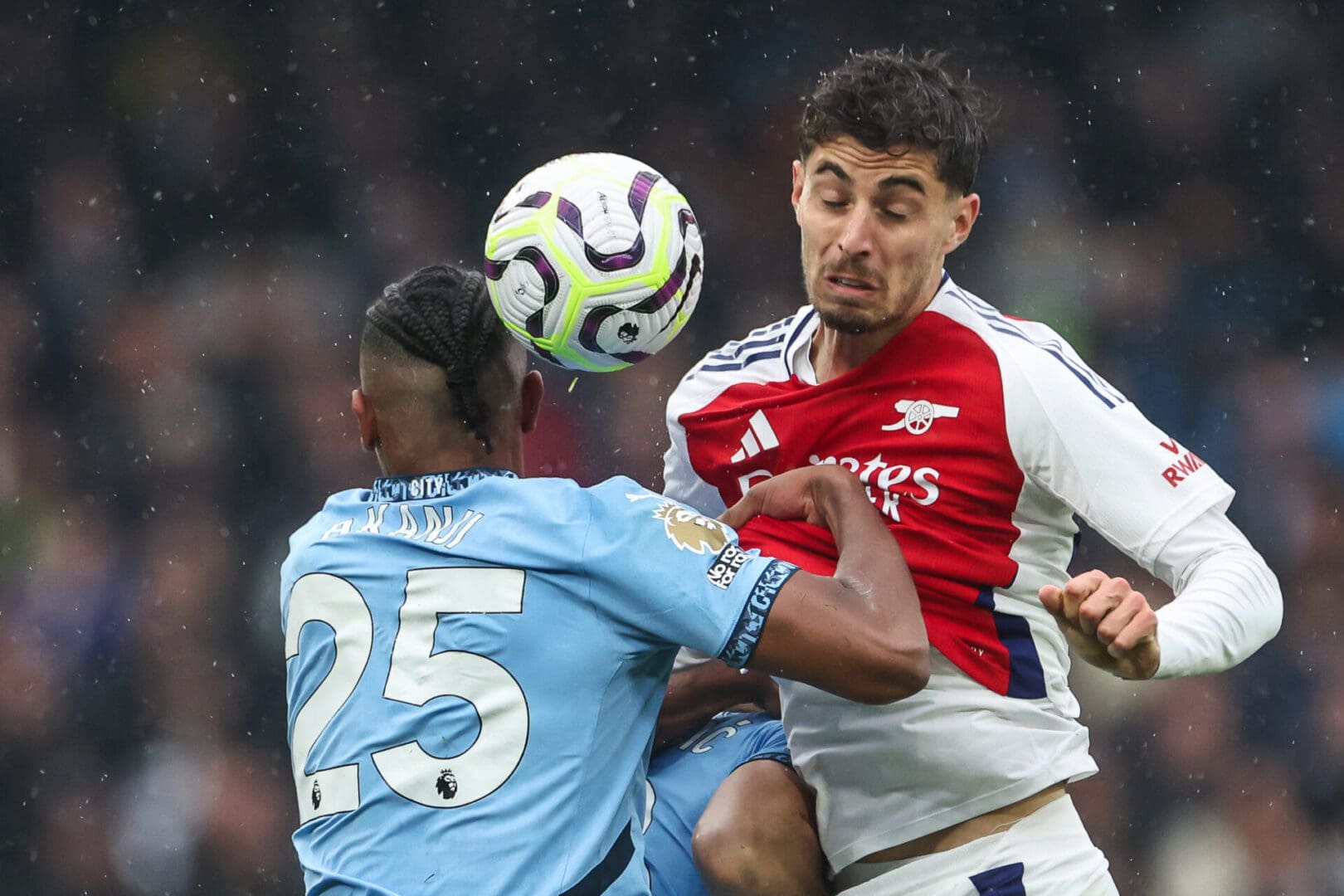 Two soccer players are playing a game of soccer.