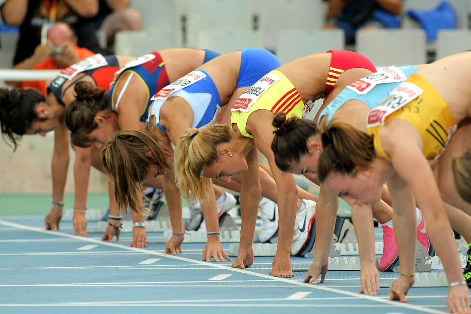 A group of women in starting position on track.