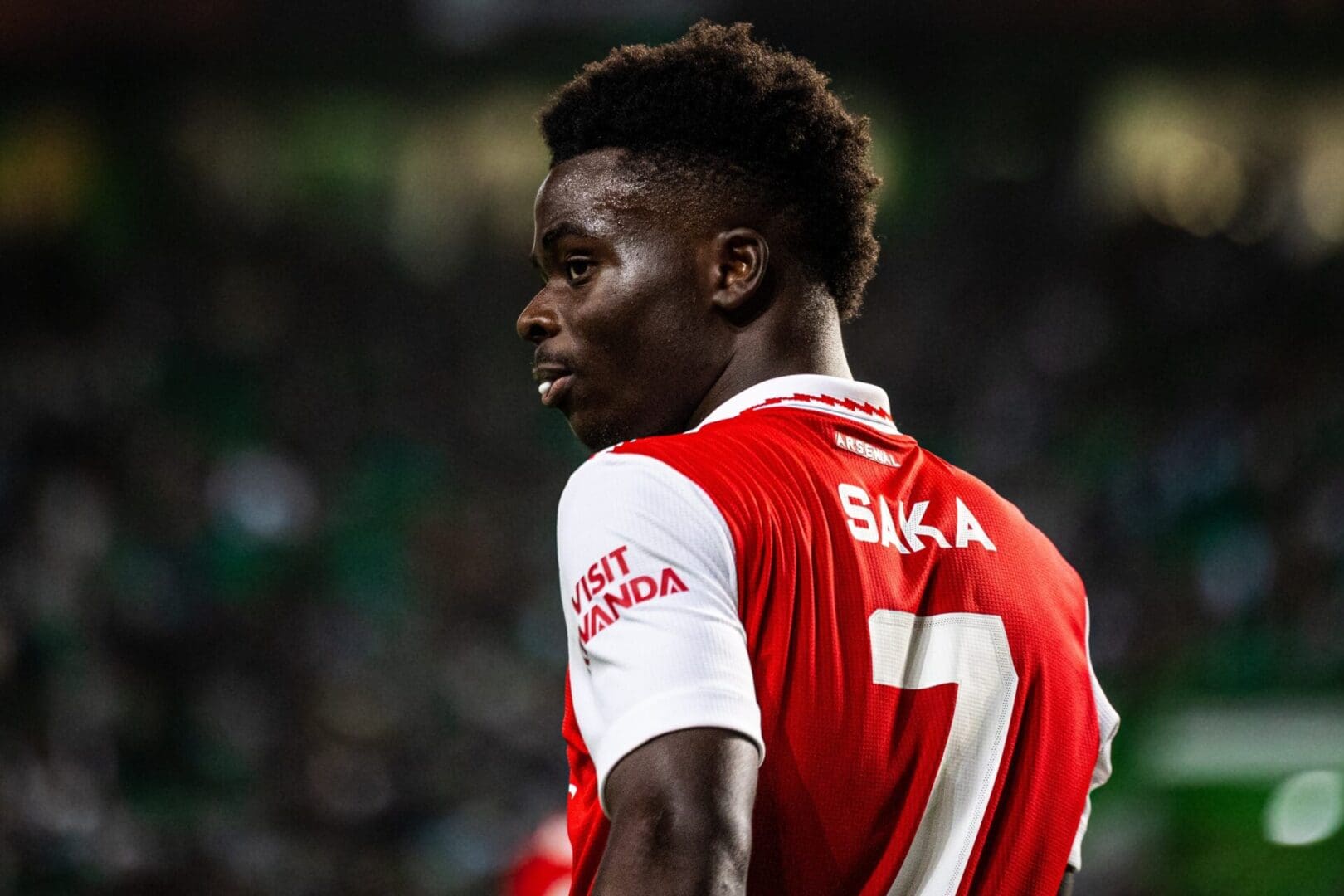 Soccer player in red jersey on field.