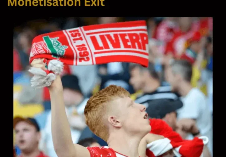 Red-haired fan waving a Liverpool scarf