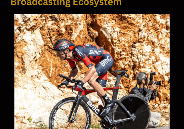 Cyclist racing with photography backdrop.