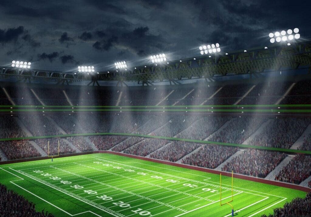 A large stadium with lights on the side of it.