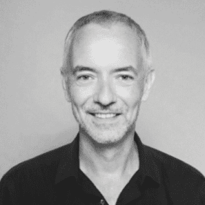 Smiling man with short grey hair.