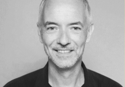 Smiling man with short grey hair.