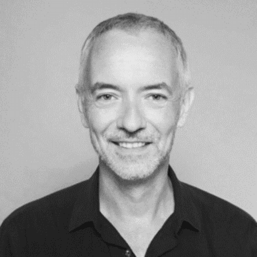 Smiling man with short grey hair.